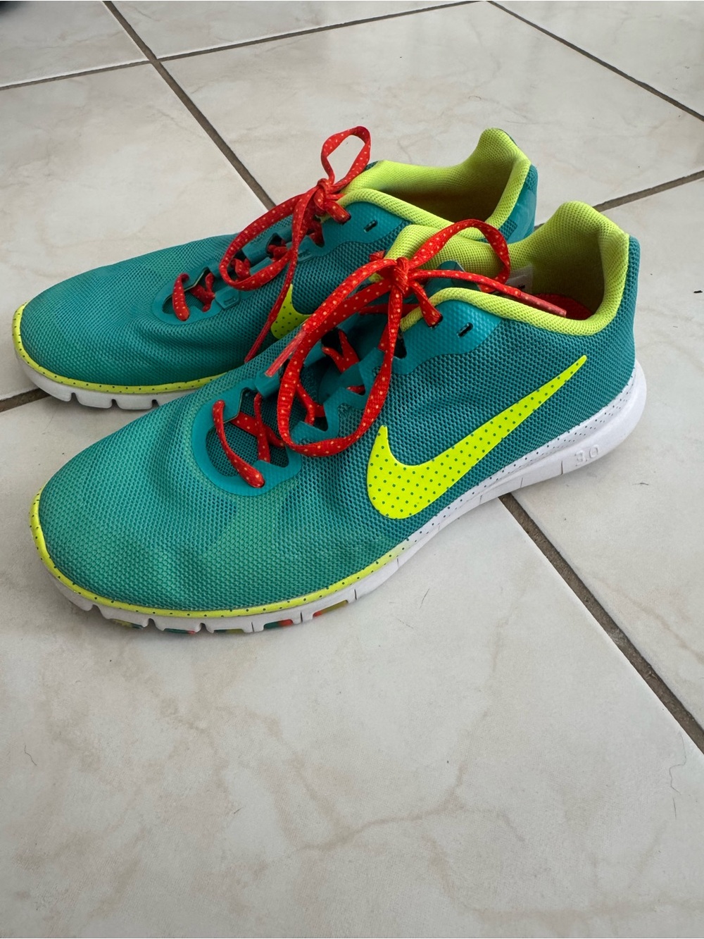 Nike women’s Teal Sneakers with Neon Yellow Swoosh and Red Laces